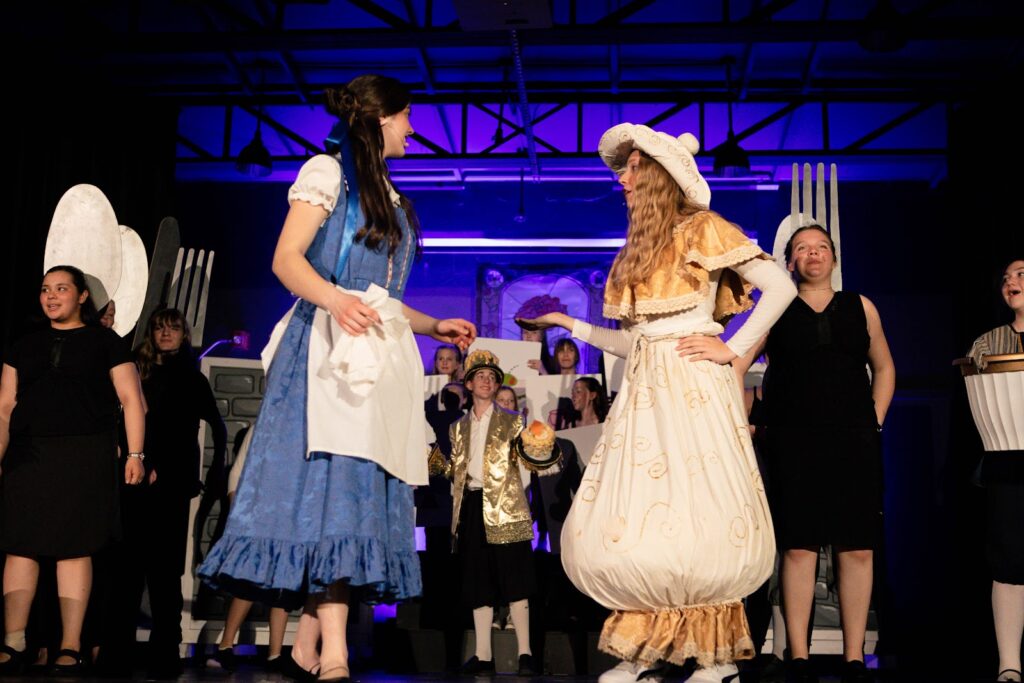 Students from Fredericton Christian Academy staging a play with elaborate costumes as an activity extracurricular.” width=