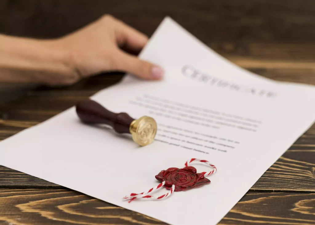 Document with red wax seal and stamp, representing certificate of completion.