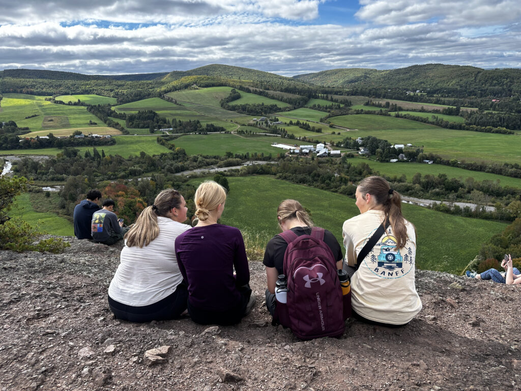 Students with backpacks observing urban landscape during an external activity, representing an educational trip.