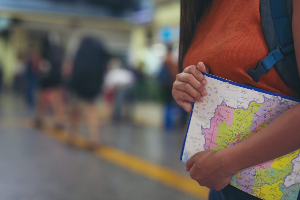 Student holding a map with school districts highlighted