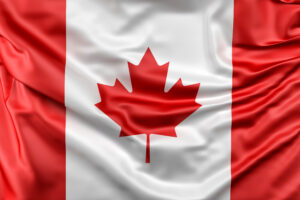 Bandeira do Canadá com folha de bordo vermelha representando a união das províncias canadenses.
