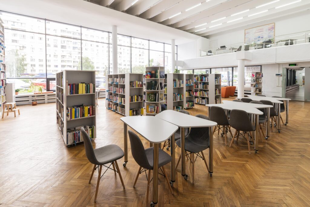 Modern and illuminated in a public school with tables and bookshelves
